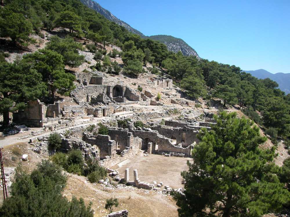 The theater of Arykanda Ancient City built upon terraces on the slopes of Şahinkaya and a panoramic valley view.