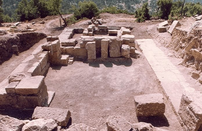 The small theater of Balboura Ancient City built on the mountain slope at an altitude of 1,600 meters and the surrounding pine forest view.