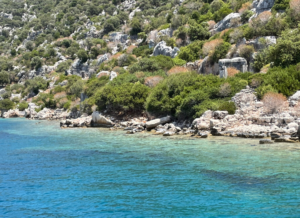 The stone stairs of Dolichiste Ancient City (Sunken City) rising out of the water on the northern coast of Kekova Island and the wall remains under the clear sea.