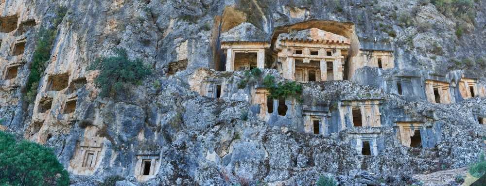 Thousands of pigeon-hole type Lycian rock-cut tombs carved side-by-side like a beehive into the steep cliff of the upper acropolis in Pinara Ancient City.