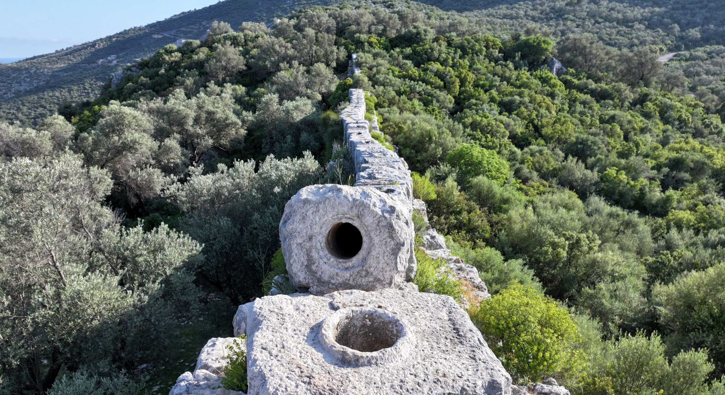 Stone blocks of the Patara Delikkemer inverted siphon pipeline, a prime example of Lycian Ancient Water Structures.
